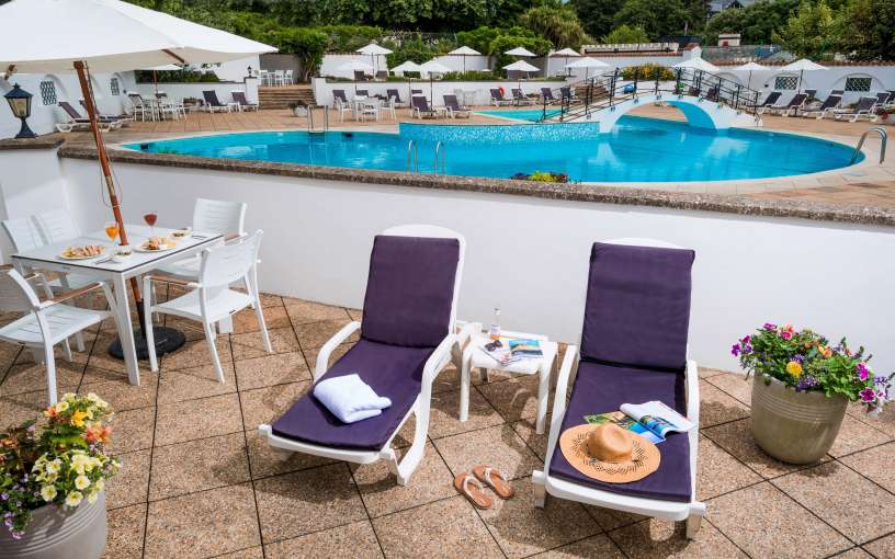 Victoria Hotel Poolside Suite Accommodation Outdoor Patio with Loungers and View of Swimming Pool