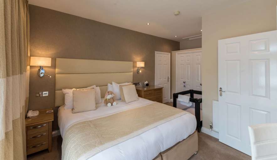 Victoria Hotel Poolside Suite Accommodation Bedroom with Cot
