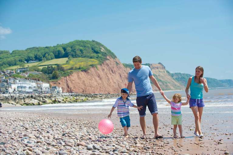 Victoria Hotel Family Walking Along Beach at Sidmouth