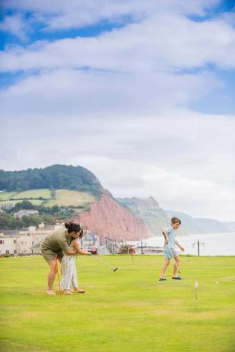 Victoria Hotel Mother and Children Enjoying a Game on the Putting Green