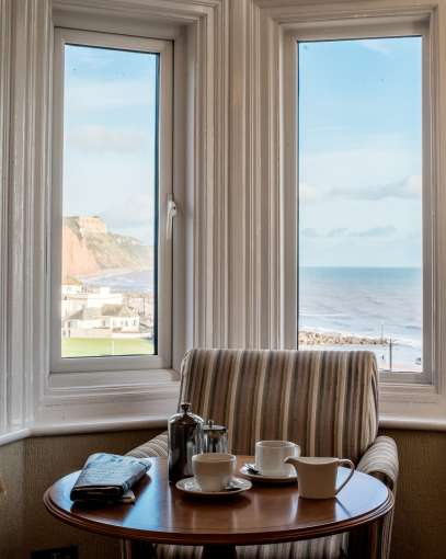 Coffee Served at Sea View Room 104 with Sidmouth Beach at Back