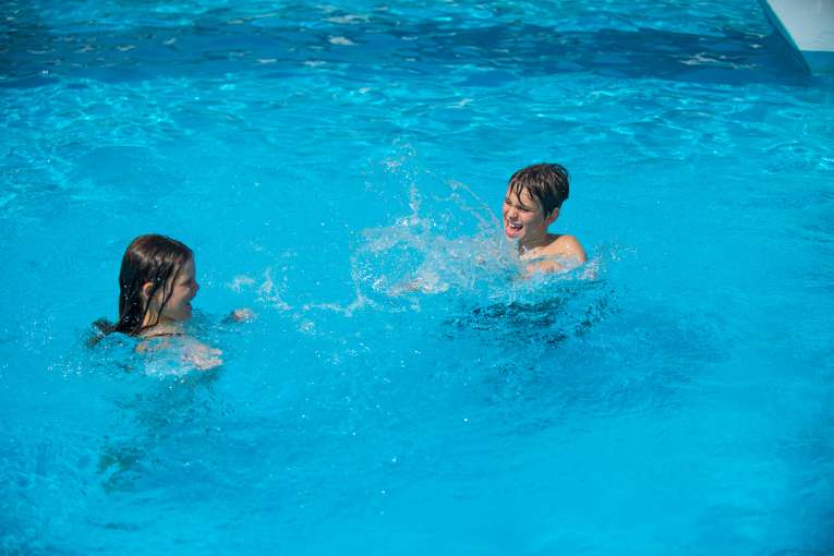children Splashing in Pool