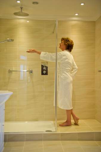 Lady checking shower at luxury room