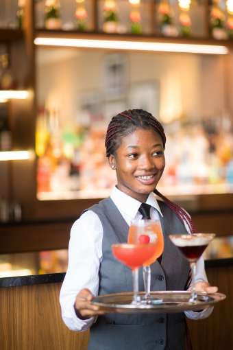 Girl Serving Cocktails at Berties Bar