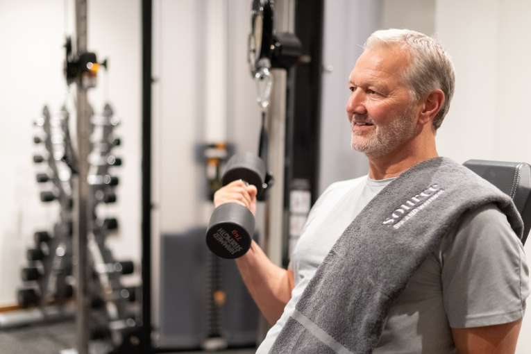 Man holding weight in gym 