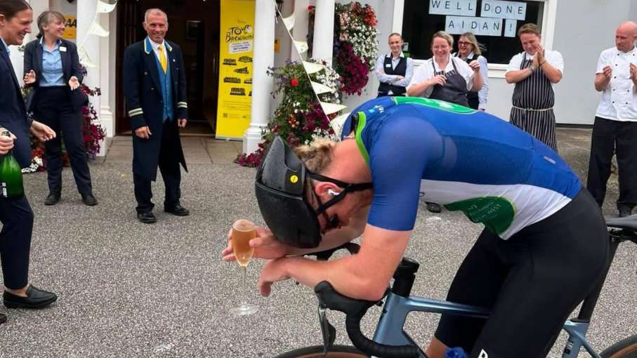 Aidan with his head in his hands after completing Tour De Brend Hotels