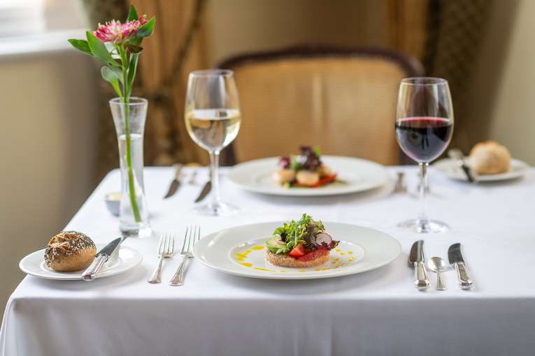 Two plates of food on white table cloth in Jubilee Restaurant
