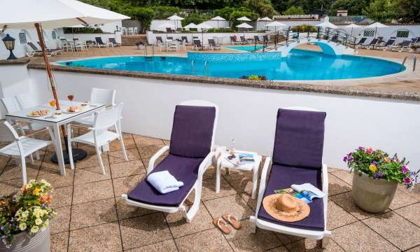 Victoria Hotel Poolside Suite Accommodation Outdoor Patio with Loungers and View of Swimming Pool