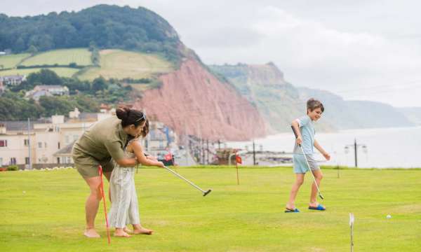 Victoria Hotel Mother and Children Enjoying a Game on the Putting Green