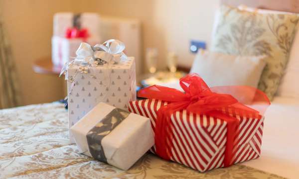 Victoria Hotel Christmas Presents on Bed in Room