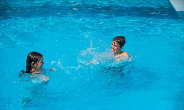 children Splashing in Pool