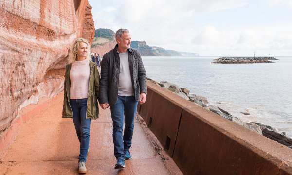 Couple Walking Along Jurassic Coast