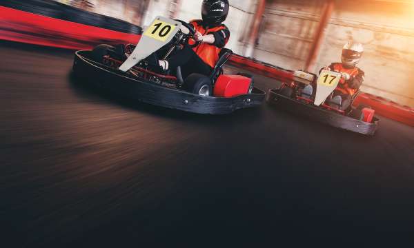 Two people racing go-karts 