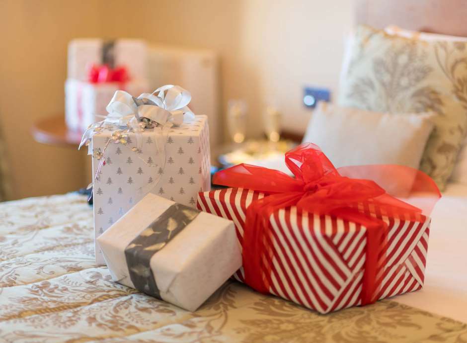 Victoria Hotel Christmas Presents on Bed in Room