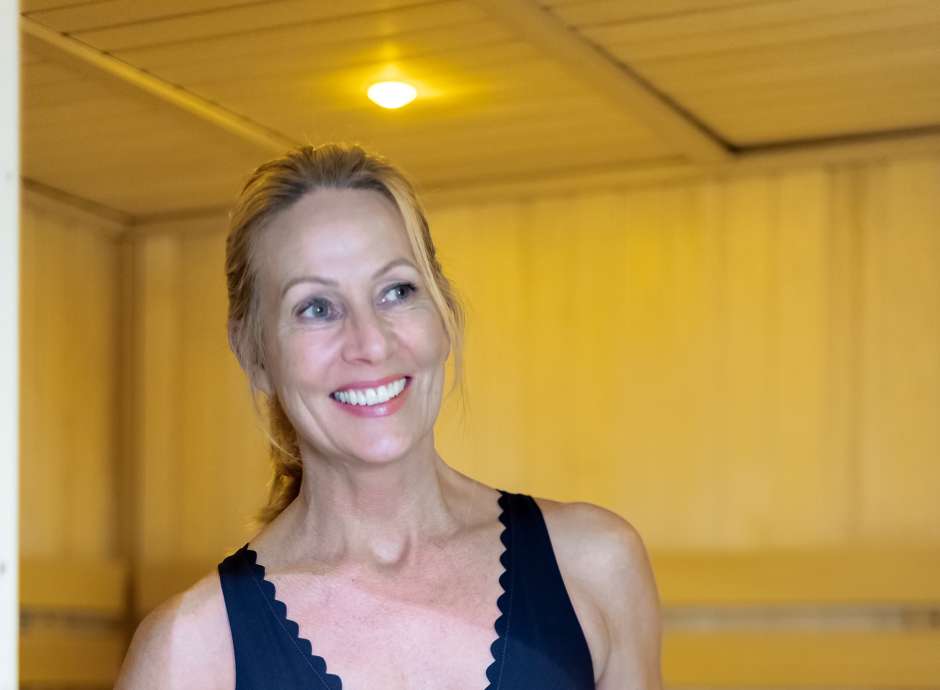 Women walking out of sauna with towel
