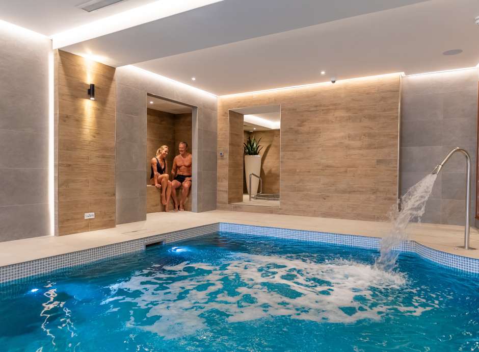 couple in seating area by pool