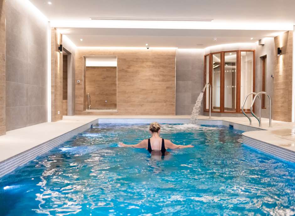 women walking in indoor pool