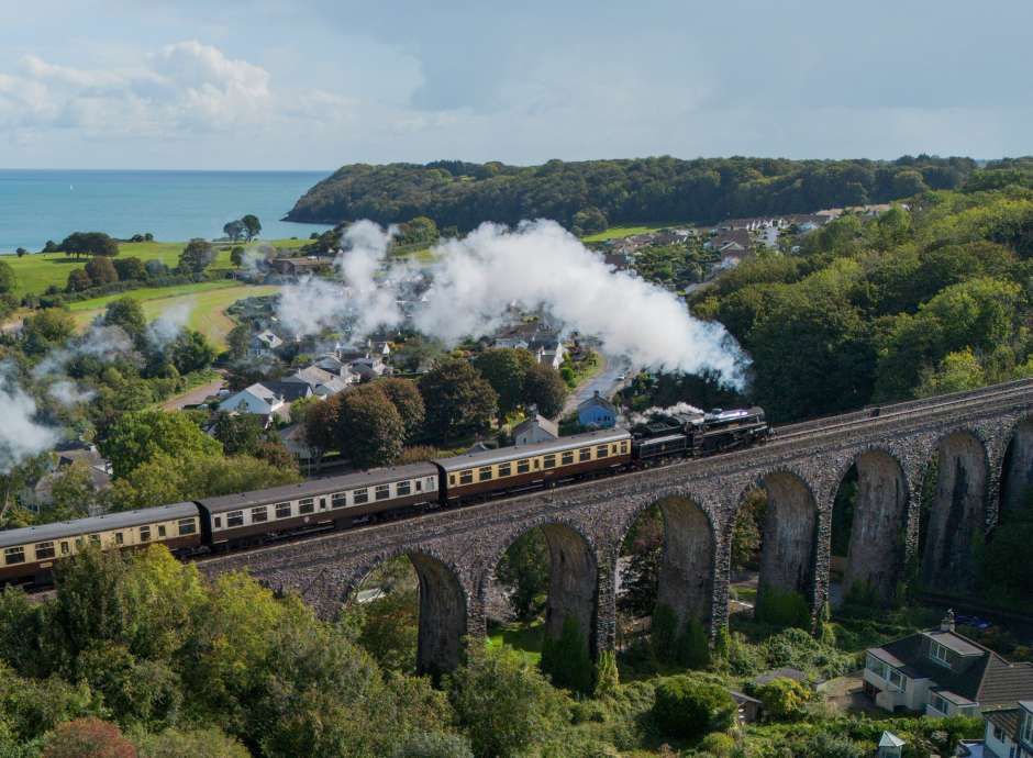 Steam train going over bridge