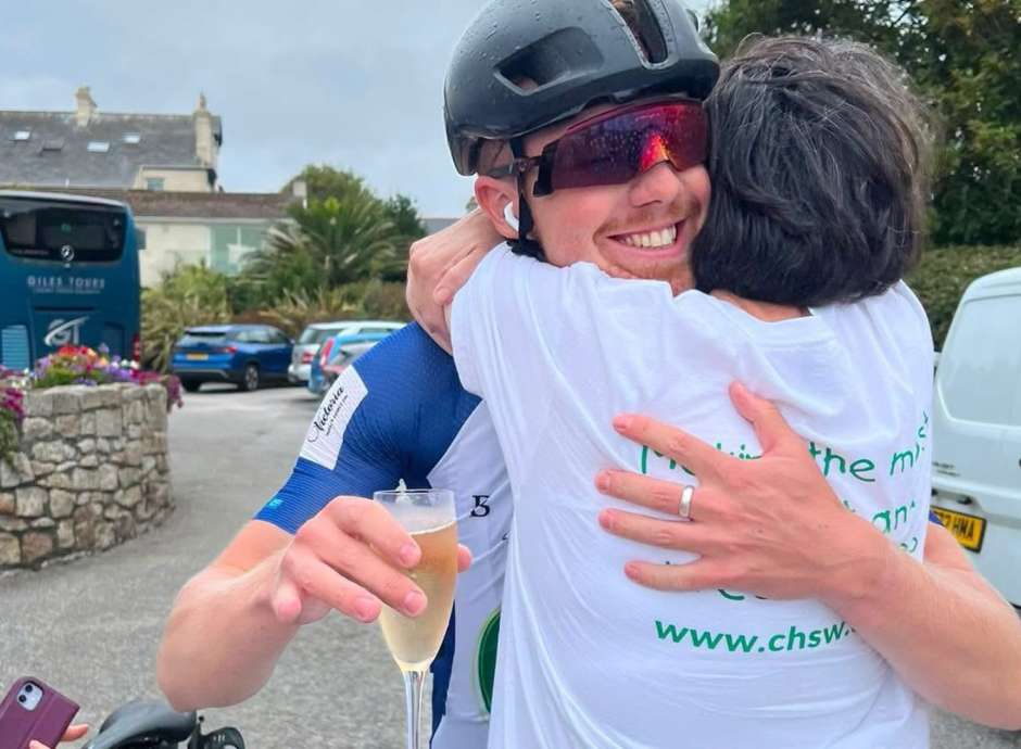 Aidan hugging fellow Brend Hotel Employee