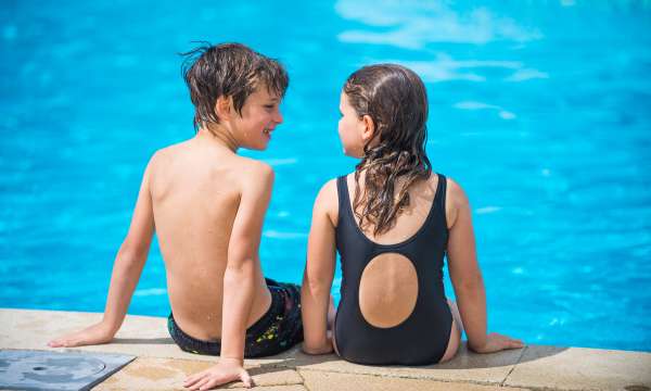 Children Looking at Each Other on Edge of Pool